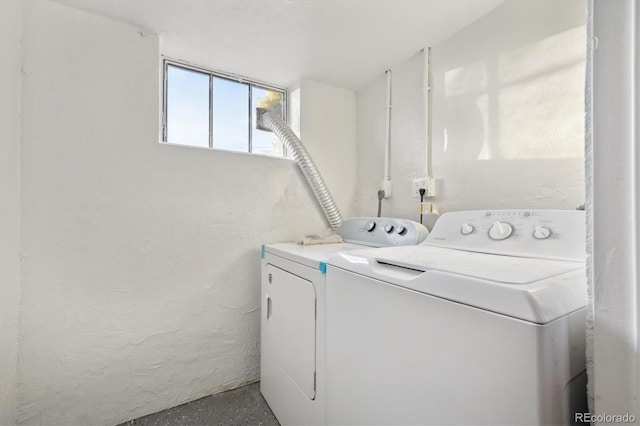 clothes washing area featuring washer and clothes dryer