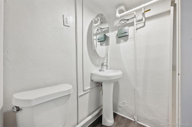 bathroom featuring hardwood / wood-style floors and toilet