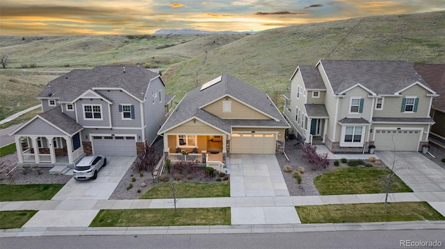 18922 W 84th Ave, Arvada, CO 80007 - view of front of home featuring a porch, driveway, and stone siding