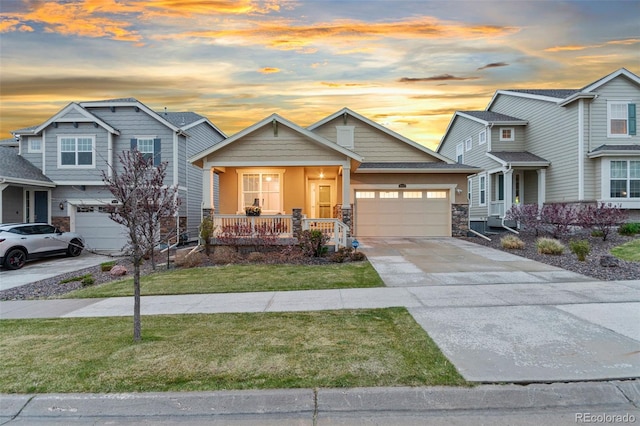 18922 W 84th Ave, Arvada, CO 80007 - view of front facade featuring a front lawn, an attached garage, stone siding, concrete driveway, and a porch