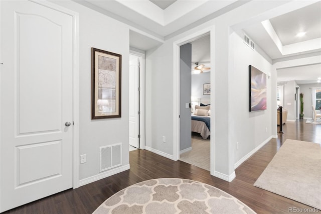 18922 W 84th Ave, Arvada, CO 80007 - hallway with baseboards, a tray ceiling, wood finished floors, and visible vents
