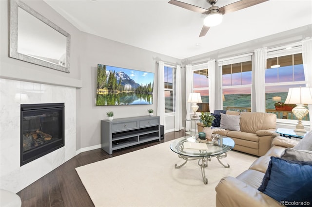 18922 W 84th Ave, Arvada, CO 80007 - living room featuring dark wood-style flooring, ceiling fan, baseboards, and a fireplace