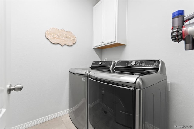 18922 W 84th Ave, Arvada, CO 80007 - laundry room with baseboards, washer and clothes dryer, cabinet space, and light tile patterned flooring