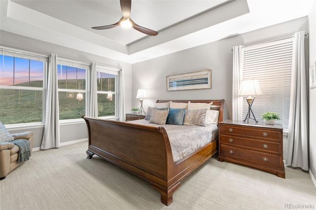 18922 W 84th Ave, Arvada, CO 80007 - bedroom featuring a ceiling fan, baseboards, light carpet, and a tray ceiling