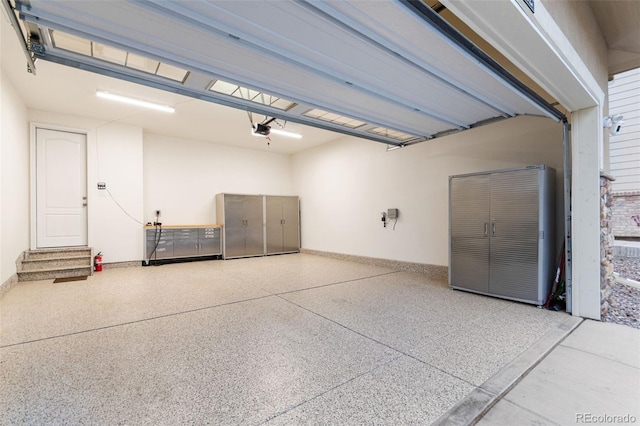 18922 W 84th Ave, Arvada, CO 80007 - garage featuring baseboards and a garage door opener