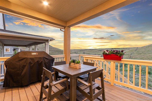 18922 W 84th Ave, Arvada, CO 80007 - deck at dusk featuring outdoor dining space and a grill