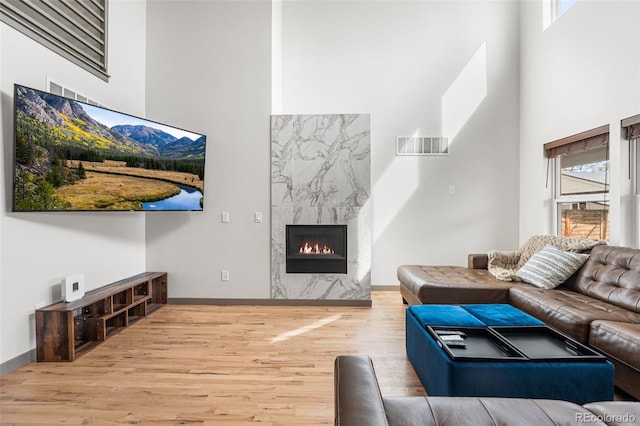 4966 Knox Ct, Denver, CO 80221 - living area with a towering ceiling, wood finished floors, and a fireplace