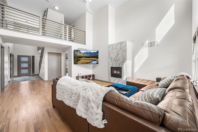 4966 Knox Ct, Denver, CO 80221 - living area with a towering ceiling, a premium fireplace, and light wood-style floors