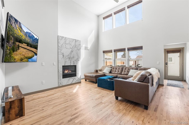 4966 Knox Ct, Denver, CO 80221 - living room featuring a high ceiling, light wood-type flooring, and a premium fireplace
