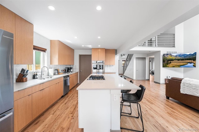 4966 Knox Ct, Denver, CO 80221 - kitchen featuring stainless steel appliances, a kitchen bar, backsplash, light countertops, and recessed lighting
