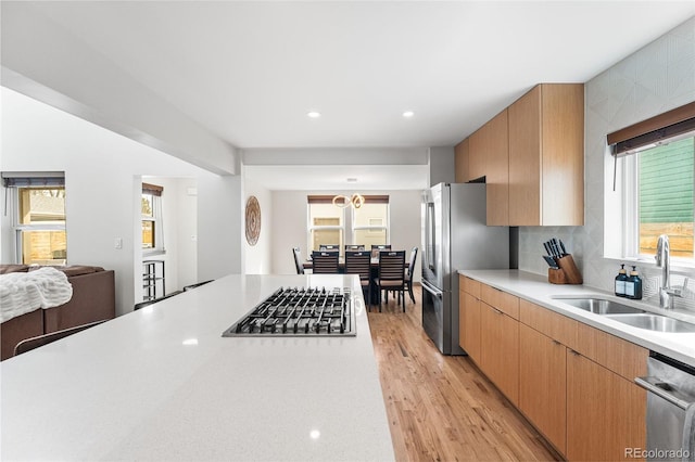 4966 Knox Ct, Denver, CO 80221 - kitchen featuring appliances with stainless steel finishes, light countertops, healthy amount of natural light, light wood-type flooring, and recessed lighting