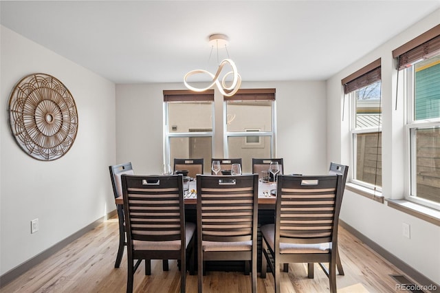 4966 Knox Ct, Denver, CO 80221 - dining room featuring light wood-type flooring and baseboards