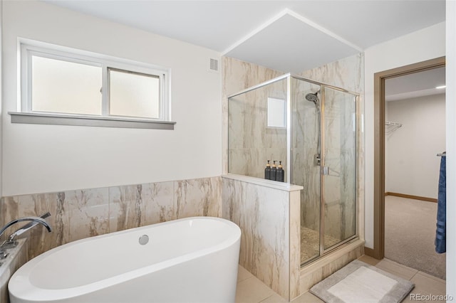 4966 Knox Ct, Denver, CO 80221 - bathroom with a freestanding tub, a shower stall, a walk in closet, and tile patterned flooring