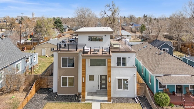 4966 Knox Ct, Denver, CO 80221 - rear view of property with stucco siding, a balcony, a residential view, and a fenced backyard