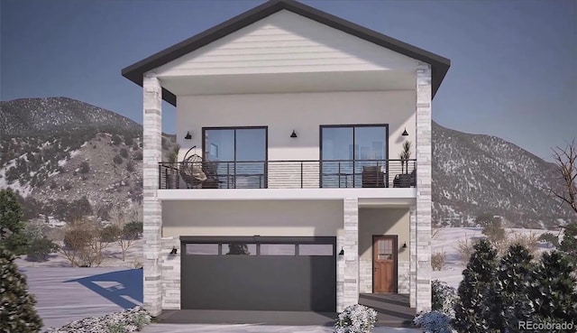 view of front of home with a balcony, a mountain view, and a garage