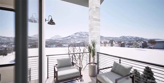 snow covered back of property featuring a mountain view