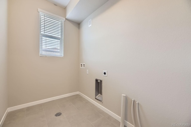 washroom featuring hookup for an electric dryer, light tile patterned floors, and hookup for a washing machine