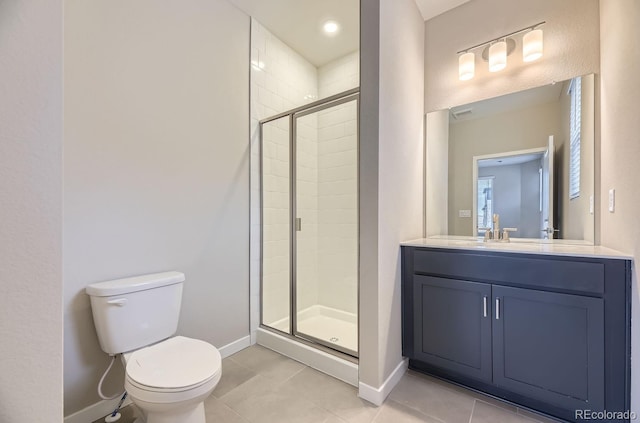 bathroom featuring tile patterned floors, a shower with door, vanity, and toilet