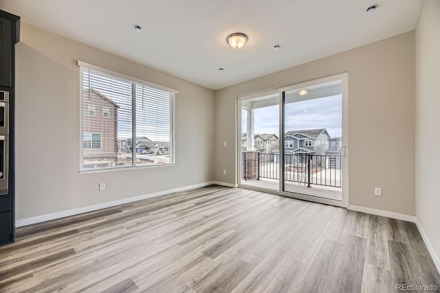 spare room with hardwood / wood-style flooring