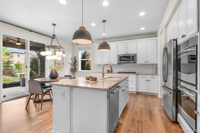 10546 Sundial Rim Rd, Highlands Ranch, CO 80126 - kitchen with a sink, stainless steel appliances, healthy amount of natural light, white cabinets, and recessed lighting
