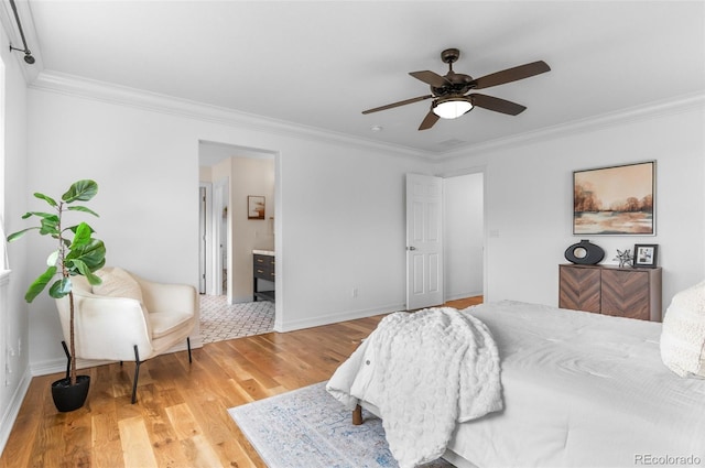 10546 Sundial Rim Rd, Highlands Ranch, CO 80126 - bedroom featuring crown molding, wood finished floors, baseboards, ceiling fan, and ensuite bath