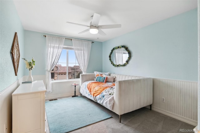 10546 Sundial Rim Rd, Highlands Ranch, CO 80126 - carpeted bedroom featuring wainscoting and a ceiling fan