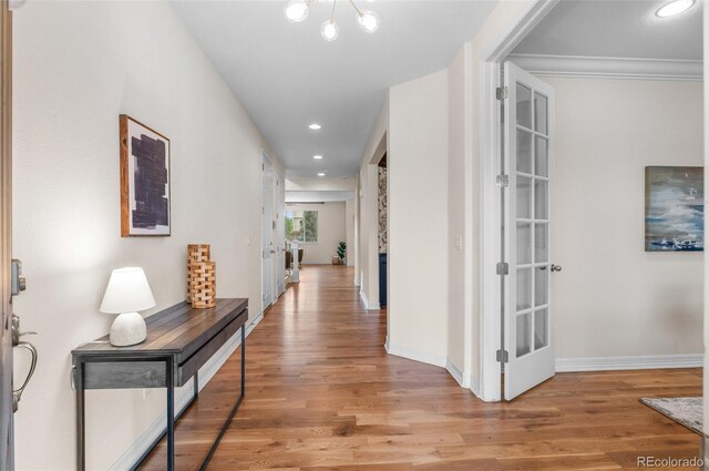 10546 Sundial Rim Rd, Highlands Ranch, CO 80126 - hall with light wood-style flooring, baseboards, recessed lighting, and a chandelier