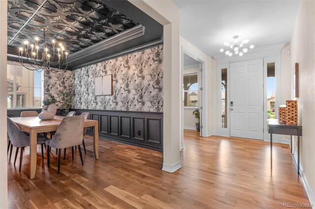 10546 Sundial Rim Rd, Highlands Ranch, CO 80126 - dining space with a chandelier, healthy amount of natural light, wood finished floors, crown molding, and wainscoting