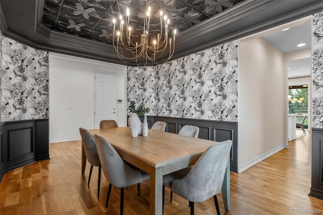 10546 Sundial Rim Rd, Highlands Ranch, CO 80126 - dining space featuring a chandelier, light wood-style floors, ornamental molding, baseboards, and a wainscoted wall