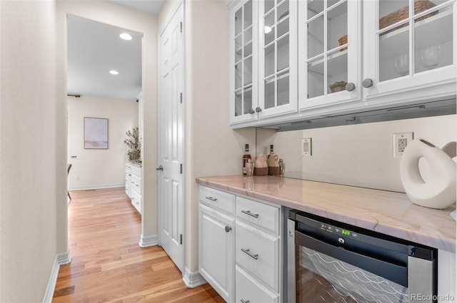 10546 Sundial Rim Rd, Highlands Ranch, CO 80126 - indoor dry bar with wine cooler, light wood-style flooring, baseboards, and recessed lighting