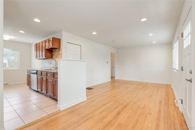 4972 W Custer Pl, Denver, CO 80219 - kitchen with stainless steel dishwasher, recessed lighting, decorative backsplash, and light wood-style floors