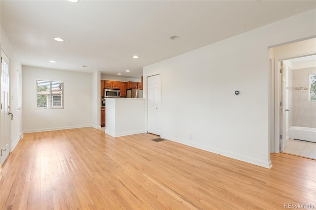 4972 W Custer Pl, Denver, CO 80219 - unfurnished living room with plenty of natural light, light wood-style flooring, and recessed lighting