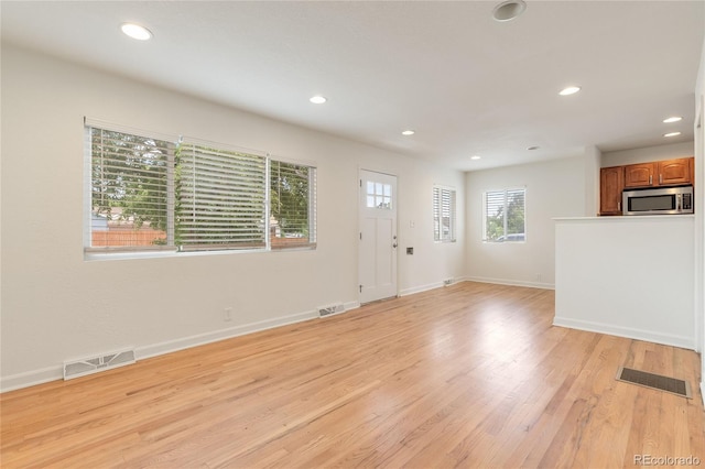 4972 W Custer Pl, Denver, CO 80219 - unfurnished living room featuring recessed lighting and light wood finished floors