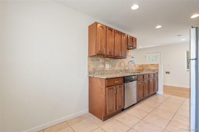 4972 W Custer Pl, Denver, CO 80219 - kitchen featuring dishwasher, backsplash, light tile patterned flooring, light stone counters, and recessed lighting