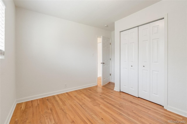 4972 W Custer Pl, Denver, CO 80219 - unfurnished bedroom featuring light wood finished floors and a closet