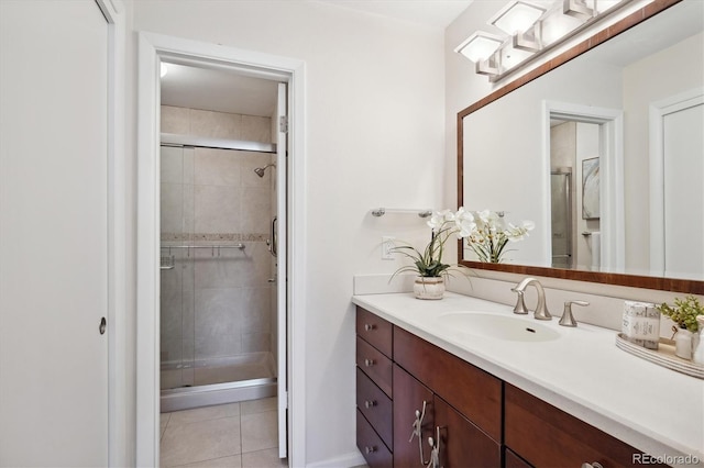 bathroom featuring tile patterned flooring, vanity, and a shower with shower door