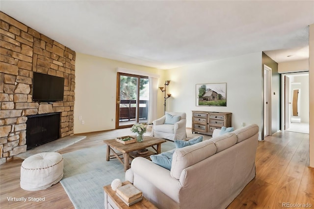 living room with a fireplace and light hardwood / wood-style flooring