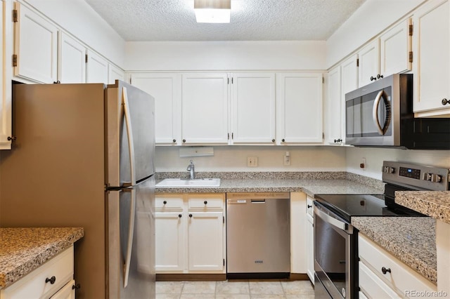 kitchen featuring white cabinetry, sink, and appliances with stainless steel finishes