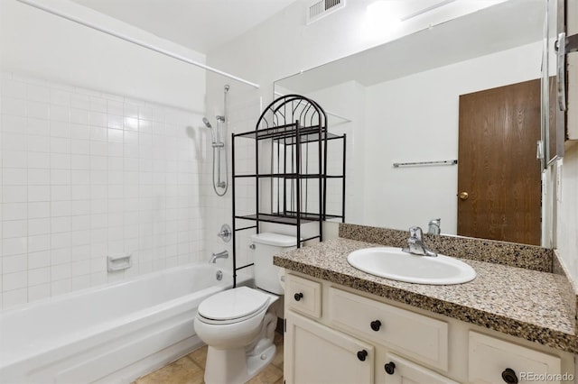 full bathroom with vanity, tiled shower / bath combo, and toilet