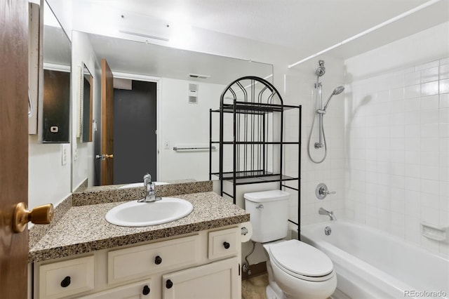 full bathroom with vanity, tiled shower / bath, and toilet