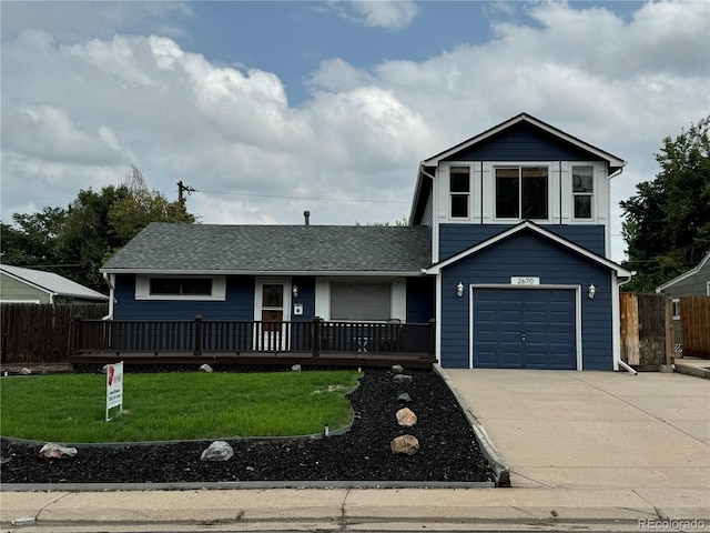 view of front of property with a front lawn and a garage