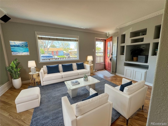 living room with built in features and ornamental molding