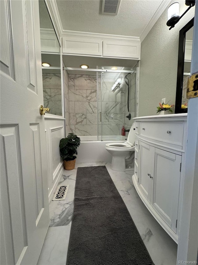 full bathroom featuring vanity, shower / bath combination with glass door, crown molding, toilet, and a textured ceiling