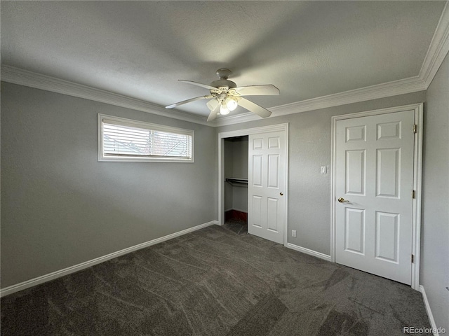 unfurnished bedroom featuring dark colored carpet, ceiling fan, and crown molding