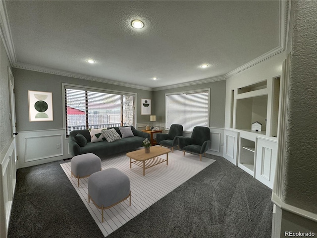 living room with built in shelves, dark carpet, a textured ceiling, and ornamental molding