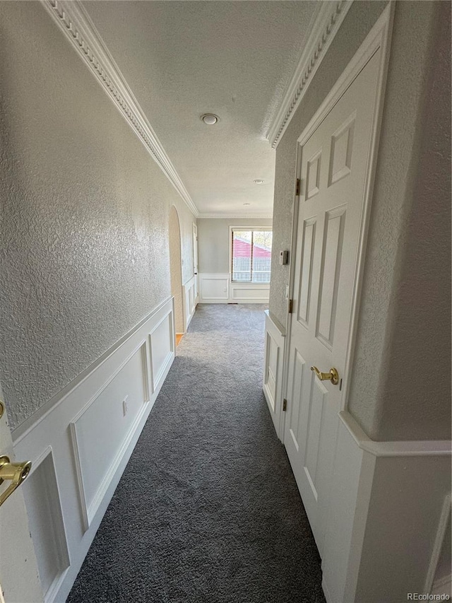 corridor with carpet flooring and ornamental molding