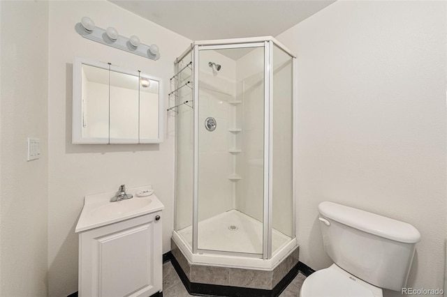 bathroom with walk in shower, vanity, and toilet