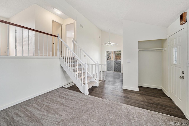 carpeted foyer entrance with vaulted ceiling and ceiling fan