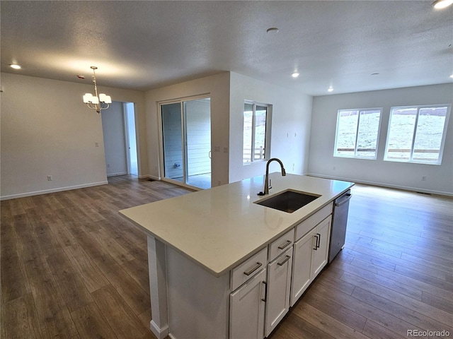 17146 W 92nd Loop, Arvada, CO 80007 - kitchen featuring open floor plan, a sink, dishwasher, a chandelier, and dark wood finished floors