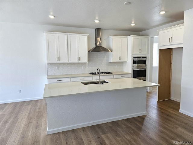 17146 W 92nd Loop, Arvada, CO 80007 - kitchen with wall chimney exhaust hood, a sink, stainless steel appliances, decorative backsplash, and recessed lighting